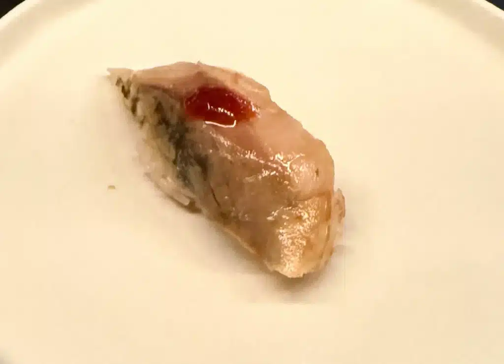 Sushi by Sea Review  Japanese mackerel nigiri topped with a small dot of red sauce.