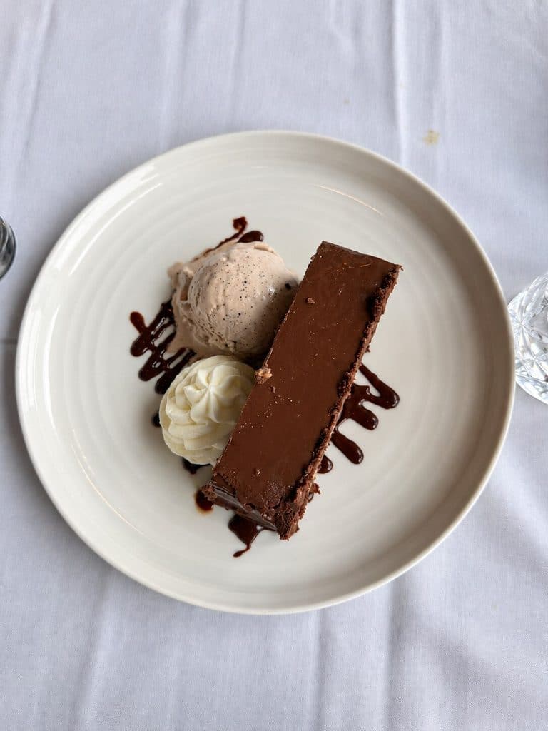 Flourless Chocolate Cake with chocolate ice cream and cream at Blu Pointe