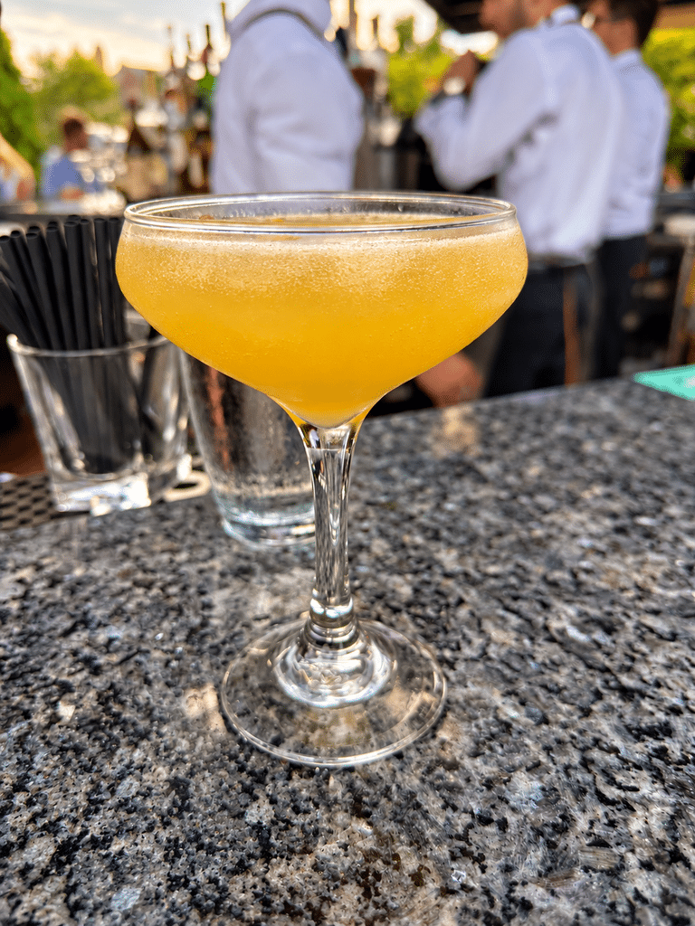 Yellow cocktail in the late-afternoon light at Blu Pointe’s waterfront bar