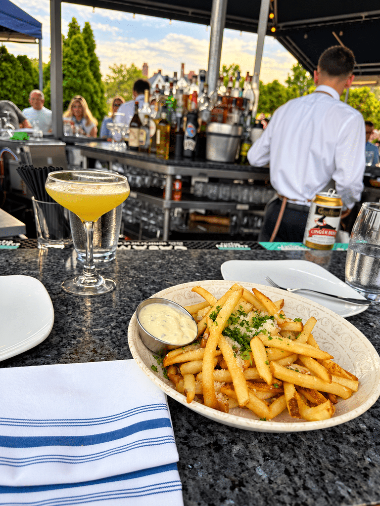 Blu Pointe Review Seasoned fries and a cocktail at Blu Pointe’s busy outdoor bar